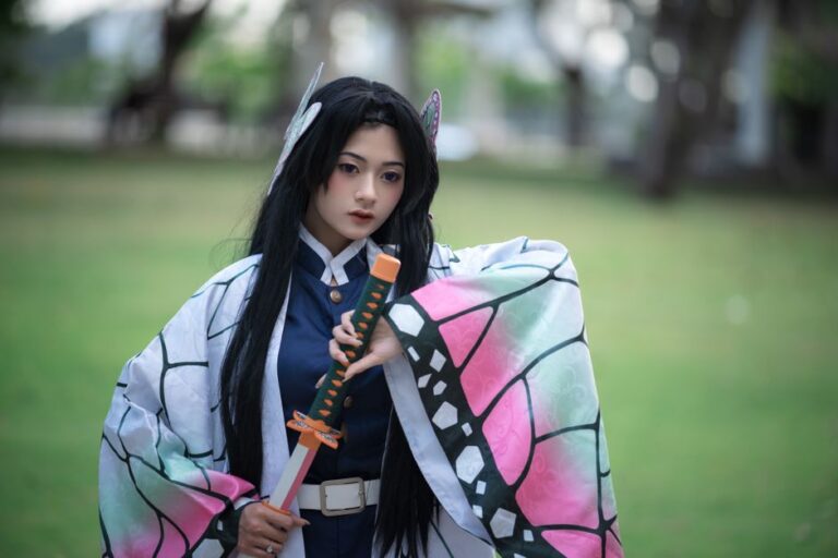 Cosplaying individual dressed as a character from anime, holding a sword in an outdoor setting.